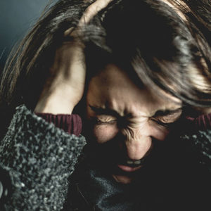 woman holding head in frustration