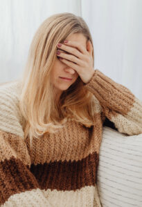 woman in sweater distressed